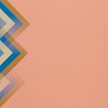 Modern abstract geometric design featuring layered triangles on a pastel background.